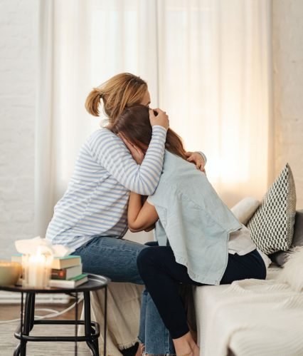 A caregiver and a senior sharing a warm moment at home
