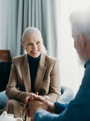 A caregiver and a smiling senior woman sharing a warm moment