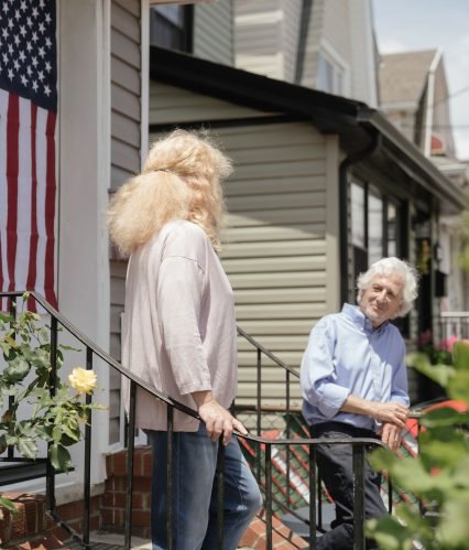An elderly couple outside their home in the Lake Houston area